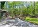 Inviting outdoor patio with stone flooring, built-in seating, and a cozy fire pit perfect for entertaining at 831 Healey Ln, Durham, NC 27705