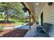 Long covered porch with seating overlooking a landscaped yard and gazebo at 831 Healey Ln, Durham, NC 27705