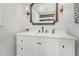 Well-lit bathroom showcases a white vanity with modern fixtures and a framed mirror at 8805 Mourning Dove Rd, Raleigh, NC 27615