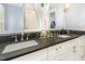 Spacious bathroom with double vanity, dark countertops and white cabinets offers abundant counter space at 8805 Mourning Dove Rd, Raleigh, NC 27615