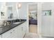 Bright bathroom features a white vanity with dark countertop, complemented by tiled shower and bedroom view at 8805 Mourning Dove Rd, Raleigh, NC 27615