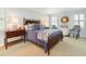 Well-lit bedroom with wooden furniture, neutral walls, and two large windows at 8805 Mourning Dove Rd, Raleigh, NC 27615