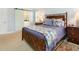 Comfortable bedroom with an ensuite bathroom, wooden furniture, and neutral walls at 8805 Mourning Dove Rd, Raleigh, NC 27615