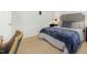 Serene bedroom featuring a queen bed, dark side table, and a cozy chair at 8805 Mourning Dove Rd, Raleigh, NC 27615