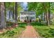 Charming two-story home with black shutters and a brick walkway leading to the front door at 8805 Mourning Dove Rd, Raleigh, NC 27615