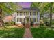 Charming two-story home with black shutters, a brick foundation, and a brick walkway leading to the front door at 8805 Mourning Dove Rd, Raleigh, NC 27615