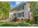 Charming two-story home with black shutters, a brick foundation, and a white railing leading to the front door at 8805 Mourning Dove Rd, Raleigh, NC 27615