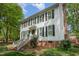 Classic two-story home with black shutters, brick accents and mature landscaping at 8805 Mourning Dove Rd, Raleigh, NC 27615