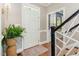Foyer featuring a hardwood floor, front door, and staircase at 8805 Mourning Dove Rd, Raleigh, NC 27615