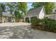 Two car garage with ample parking, adjacent to an outbuilding and fenced yard at 8805 Mourning Dove Rd, Raleigh, NC 27615