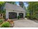 Two car garage with ample parking, adjacent to an outbuilding and fenced yard at 8805 Mourning Dove Rd, Raleigh, NC 27615