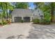 Spacious two-car garage with an expansive driveway and well-maintained landscaping at 8805 Mourning Dove Rd, Raleigh, NC 27615
