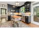 Modern kitchen features stainless steel appliances, dark cabinetry, and a stylish kitchen island at 8805 Mourning Dove Rd, Raleigh, NC 27615