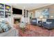 Cozy living room with a large television, fireplace, bookshelves, and comfortable seating at 8805 Mourning Dove Rd, Raleigh, NC 27615