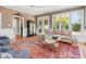 Bright living room with large windows, neutral colors, and a decorative area rug at 8805 Mourning Dove Rd, Raleigh, NC 27615