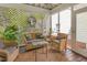 Cozy screened porch with wicker furniture and lattice details at 8805 Mourning Dove Rd, Raleigh, NC 27615