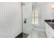 Modern shower with glass enclosure, sleek fixtures, and unique tile design at 8805 Mourning Dove Rd, Raleigh, NC 27615