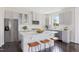 Modern kitchen with white cabinets, stainless steel appliances, and a spacious center island at 900 Emmer St, Rolesville, NC 27571