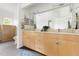 Bright bathroom featuring double vanity, large mirror, and plenty of storage at 97302 Dobbs, Chapel Hill, NC 27517