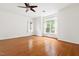 Expansive bedroom featuring hardwood floors, ceiling fan, and large windows at 97302 Dobbs, Chapel Hill, NC 27517