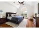 Vaulted bedroom with hardwood floors, ceiling fan and an arched doorway leading to a balcony at 97302 Dobbs, Chapel Hill, NC 27517