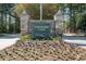 Stone monument sign for Governors Club, surrounded by colorful landscaping and mature trees at 97302 Dobbs, Chapel Hill, NC 27517