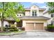 Charming two-story home with a stone-accented entrance, two-car garage, and mature landscaping at 97302 Dobbs, Chapel Hill, NC 27517