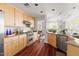 Well-lit kitchen features stainless steel appliances, custom cabinetry, and hardwood floors at 97302 Dobbs, Chapel Hill, NC 27517