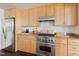 Bright kitchen with stainless steel appliances, granite countertops, and light wood cabinetry at 97302 Dobbs, Chapel Hill, NC 27517