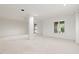 Spacious living room featuring large windows, neutral carpet, and recessed lighting at 97302 Dobbs, Chapel Hill, NC 27517