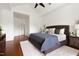 Large primary bedroom boasts a ceiling fan, hardwood floors, and a large window at 97302 Dobbs, Chapel Hill, NC 27517