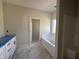 Elegant bathroom featuring a soaking tub and vanity with ample storage space, a tranquil space at 1008 Peedin Rd, Selma, NC 27576