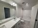 Modern bathroom featuring sleek vanity, updated fixtures, and a shower-tub combination at 1008 Peedin Rd, Selma, NC 27576