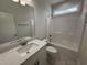 Clean bathroom with quartz countertop vanity, shower with tub, and neutral finishes at 1008 Peedin Rd, Selma, NC 27576