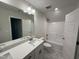 Bright bathroom features dual vanities, full mirror, and a shower over tub at 1008 Peedin Rd, Selma, NC 27576