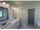 Bright bathroom with double sinks, hexagon tile flooring, and separate room for the toilet and shower/bath at 1008 Peedin Rd, Selma, NC 27576