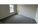 Cozy bedroom featuring carpet flooring and natural light from one window at 1008 Peedin Rd, Selma, NC 27576