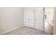 Cozy carpeted bedroom with closet and open door providing a sneak peak into the living space at 1008 Peedin Rd, Selma, NC 27576
