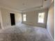 Spacious bedroom with a tray ceiling, bathed in natural light from two windows, creating a serene retreat at 1008 Peedin Rd, Selma, NC 27576