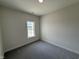 Clean bedroom with carpet and a window looking out onto a rural landscape at 1008 Peedin Rd, Selma, NC 27576