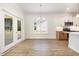 Dining area showcasing the chandelier, doors to the outside, and the eat-in kitchen at 1008 Peedin Rd, Selma, NC 27576