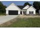 Charming new construction home with a black garage door and stone accents at 1008 Peedin Rd, Selma, NC 27576