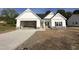 Charming new home with a welcoming entrance and attached garage, perfect for modern living at 1008 Peedin Rd, Selma, NC 27576