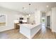 Eat-in kitchen featuring white cabinets, stainless appliances, and large peninsula at 1008 Peedin Rd, Selma, NC 27576