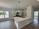 Modern kitchen with a large island, white cabinets, and stainless steel appliances at 1008 Peedin Rd, Selma, NC 27576