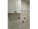 Clean laundry room with white cabinets and a wire rack shelving system for easy organization at 1008 Peedin Rd, Selma, NC 27576