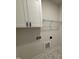 Laundry room with white cabinets, wire shelving, and modern fixtures at 1008 Peedin Rd, Selma, NC 27576