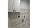 Functional laundry area features cabinet storage and room for washer and dryer hookups at 1008 Peedin Rd, Selma, NC 27576