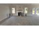 Sunlit living area with a cozy fireplace, and large windows, offering a warm and inviting atmosphere at 1008 Peedin Rd, Selma, NC 27576