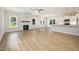 Spacious open floor plan featuring light wood-look floors, fireplace, and bright kitchen at 1008 Peedin Rd, Selma, NC 27576
